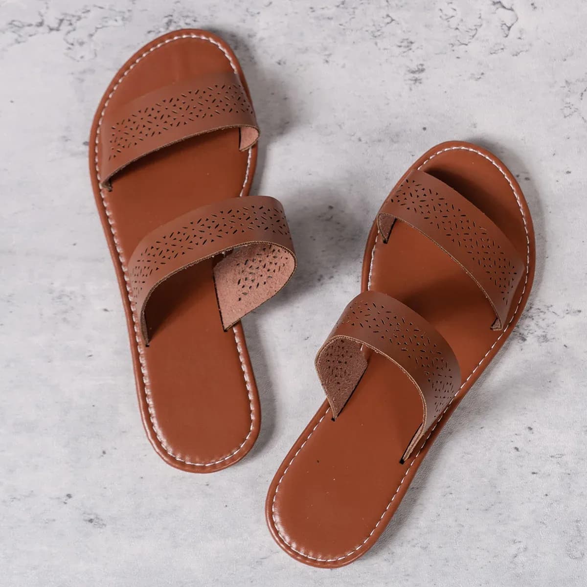 pair of brown women's flat slide sandals laid flat