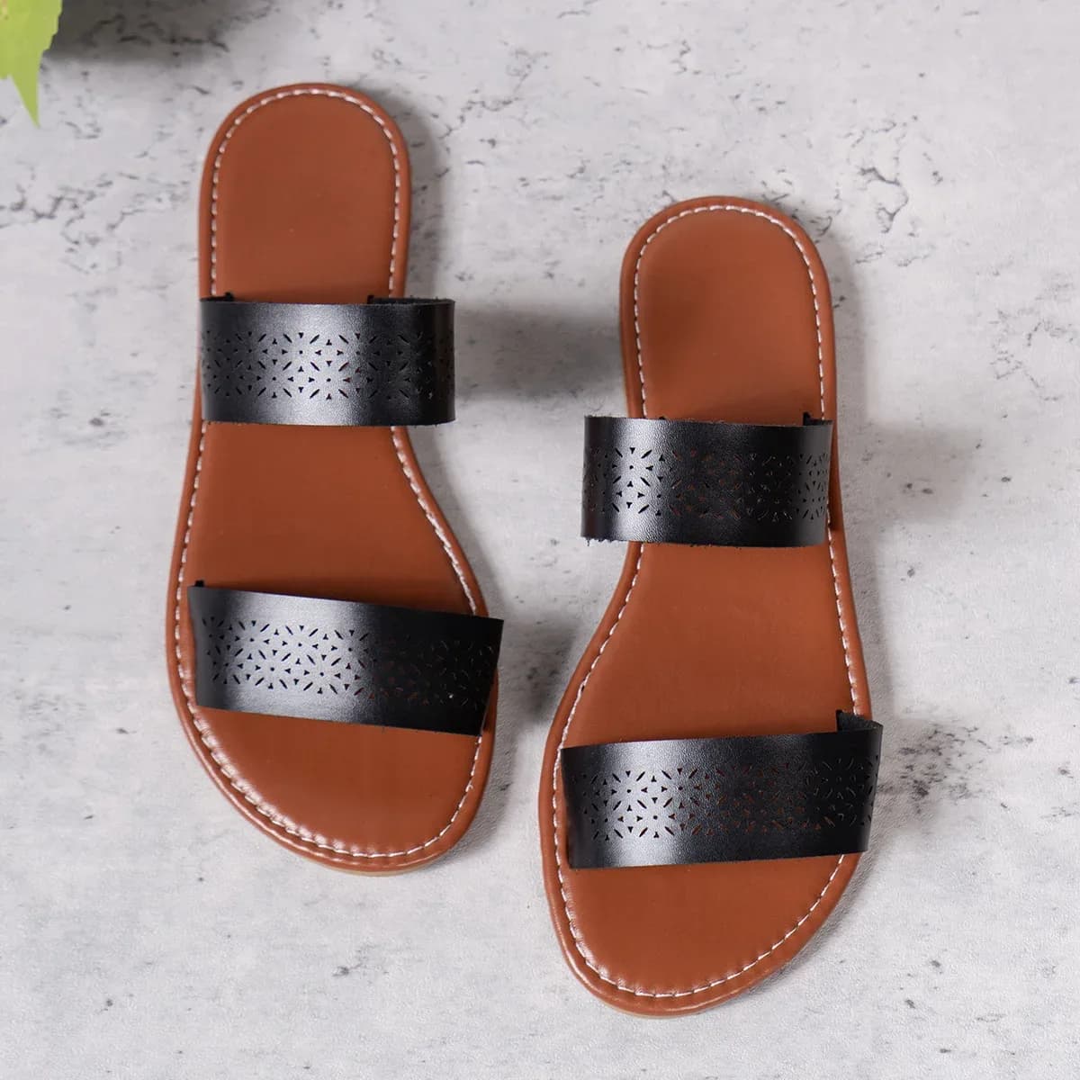 pair of black flat slide sandals with perforated straps