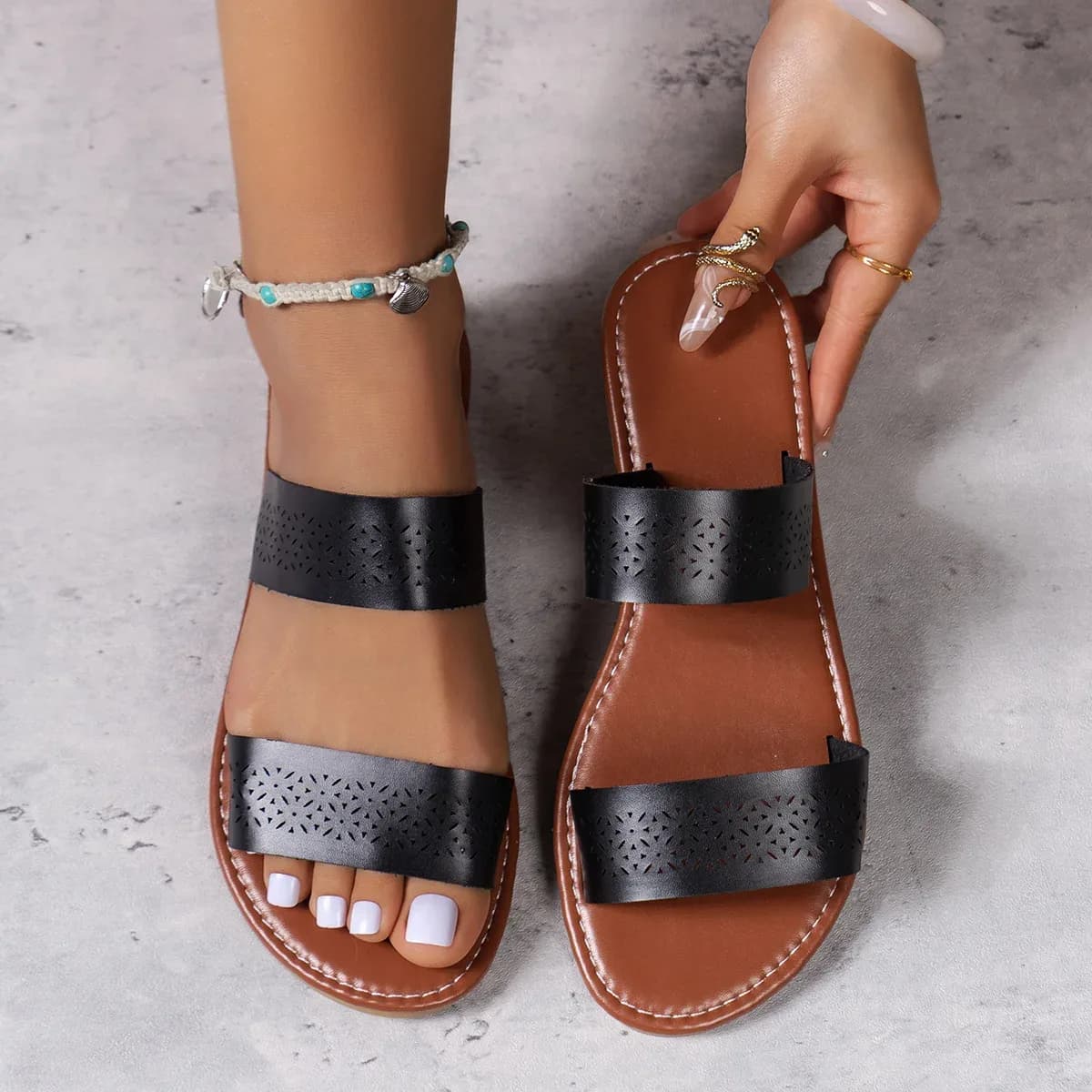 brown and black women's flat slide sandals side by side