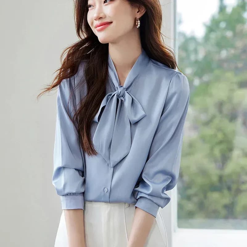 light blue satin tie neck bow blouse worn outdoors