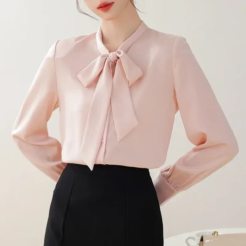pink satin tie neck bow blouse with a black skirt