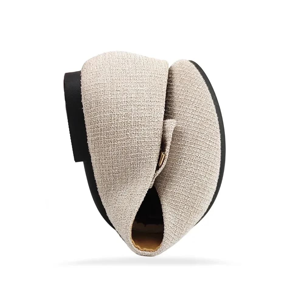 beige woven texture ballet flat folded to show how flexible it is