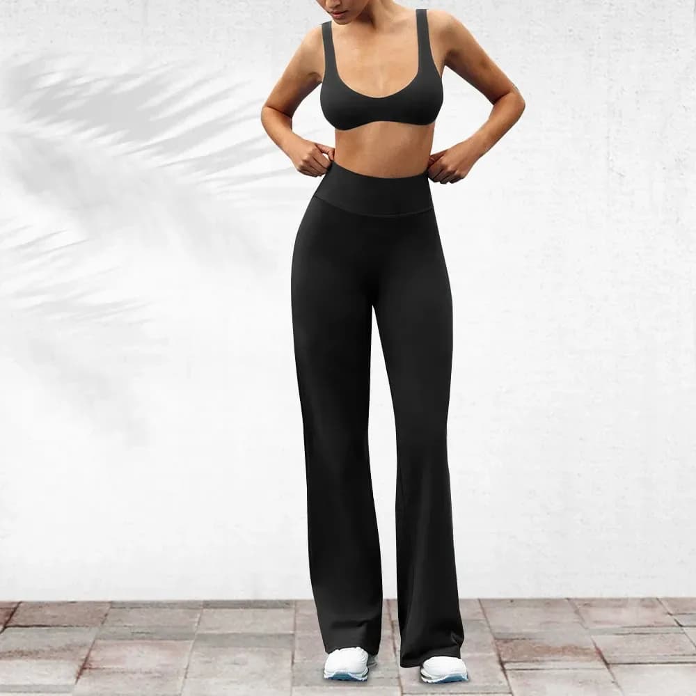 high waistband of black stretch flare work pants worn front on