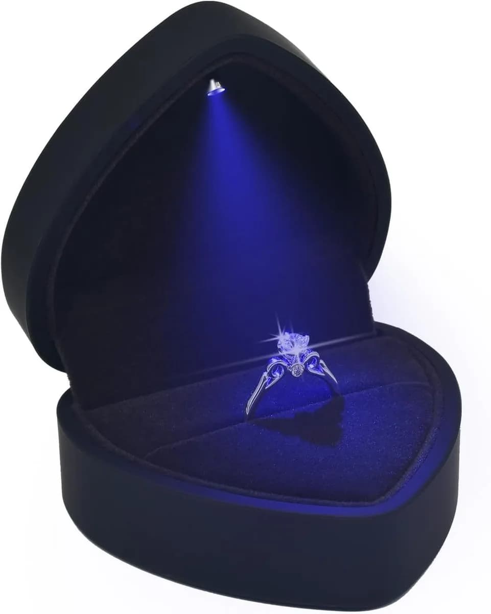 black heart shaped LED ring box lit up with an engagement ring inside