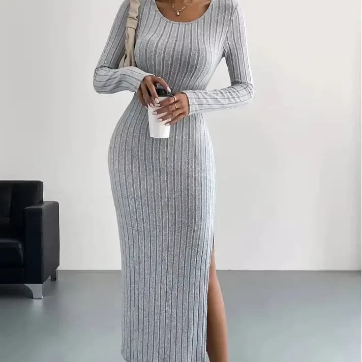 woman in a light grey ribbed knit bodycon midi dress with side slit