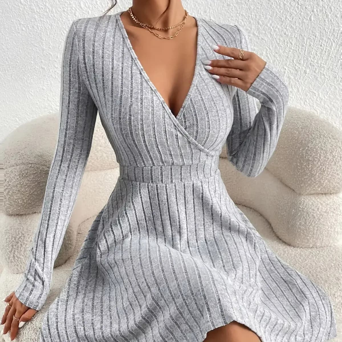 woman in a grey wrap V neck ribbed sweater dress with long sleeves