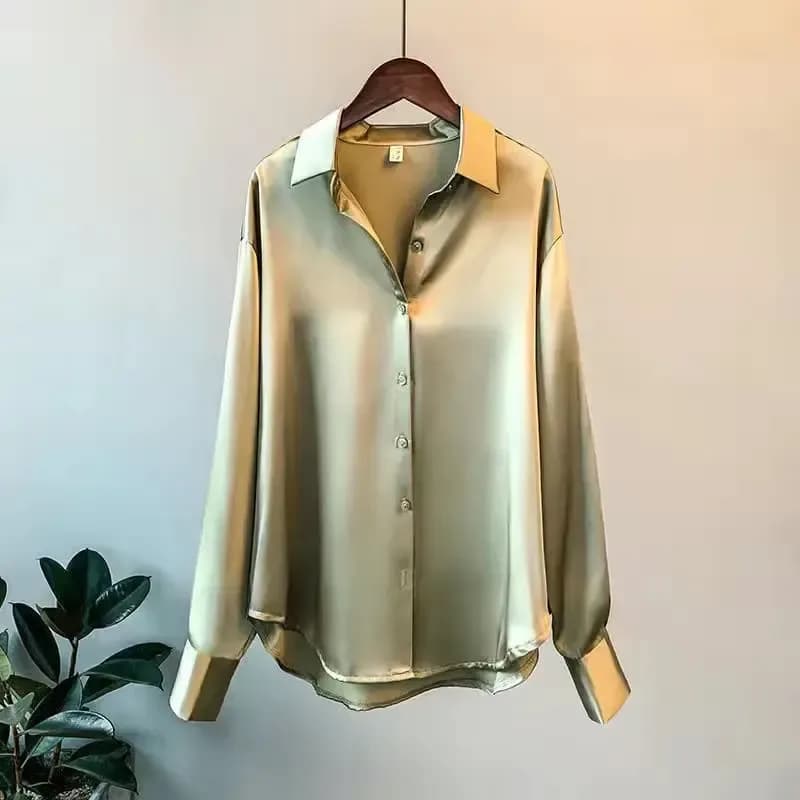 green oversized satin button down shirt with long sleeves on a hanger