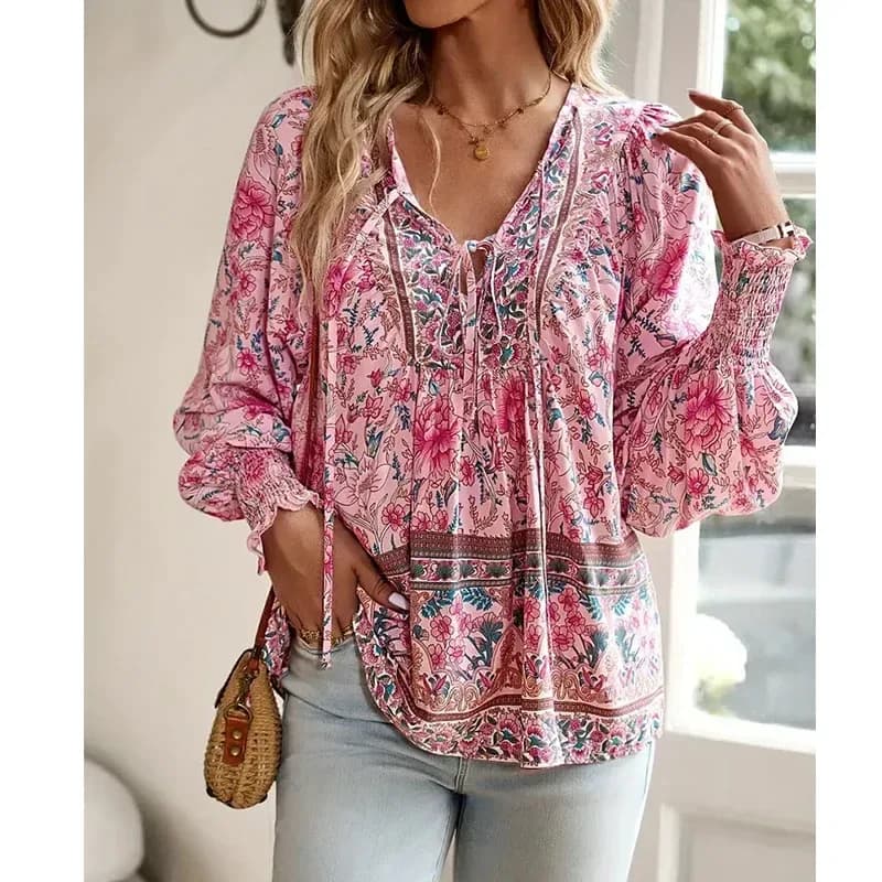woman wearing a pink boho floral print blouse with tie V-neck and light jeans
