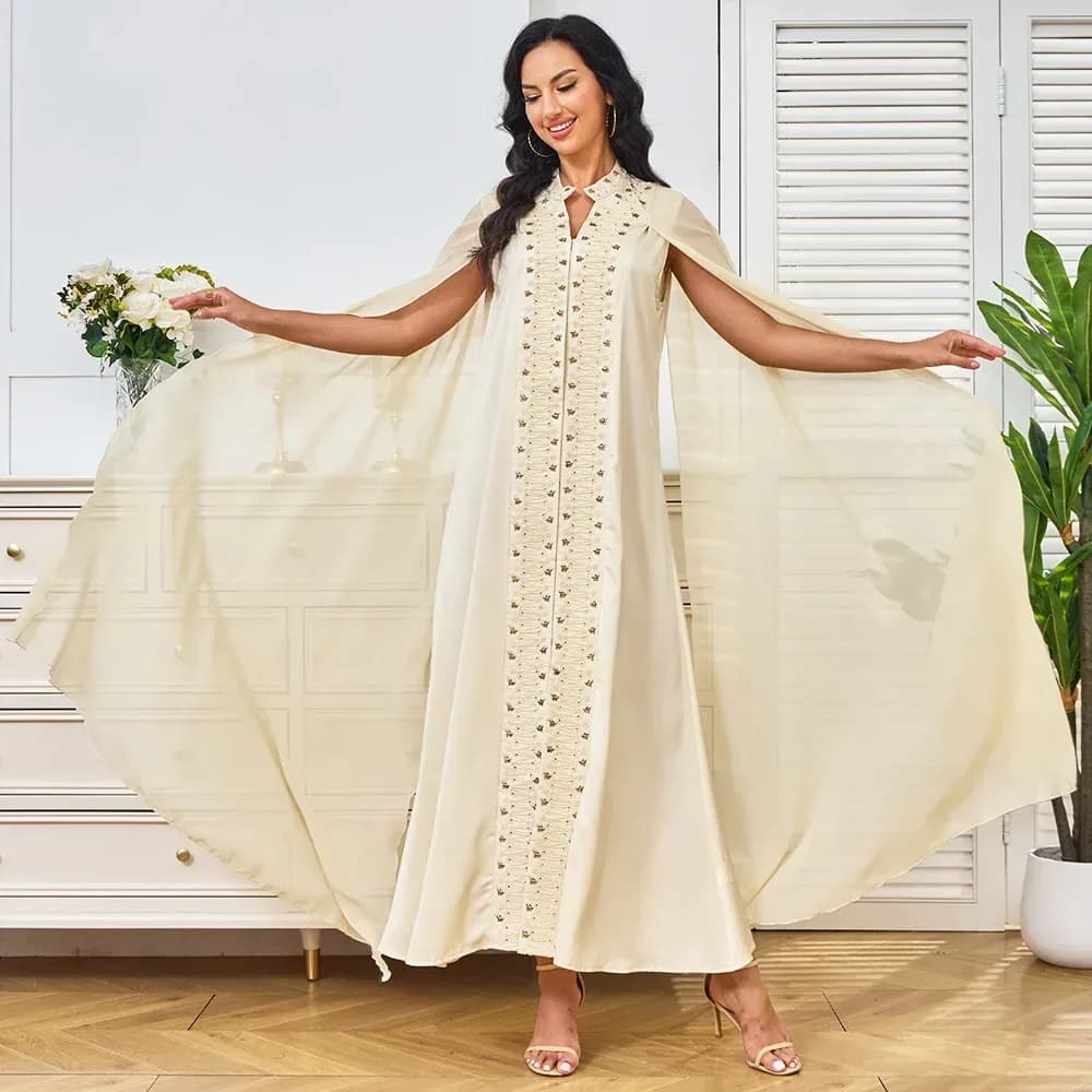 woman wearing an apricot beaded embroidered evening maxi dress with chiffon cape sleeves